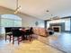 Open-concept living area with dining table, fireplace, and comfortable seating arrangement with neutral colors at 10941 Hilltop Dr, New Port Richey, FL 34654