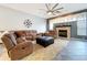 Cozy living room with a fireplace, plush seating, and ample space for relaxation and entertainment at 10941 Hilltop Dr, New Port Richey, FL 34654