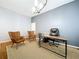 Office room features neutral paint color and minimalist furniture arrangement at 10941 Hilltop Dr, New Port Richey, FL 34654