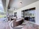Covered patio featuring an outdoor kitchen, seating, and view of the pool at 10941 Hilltop Dr, New Port Richey, FL 34654