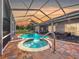 Screened-in pool with hot tub and outdoor seating, perfect for entertaining at 10941 Hilltop Dr, New Port Richey, FL 34654