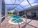 Screened pool area with a pool, spa, brick patio, and outdoor seating area, with part of the house visible at 10941 Hilltop Dr, New Port Richey, FL 34654