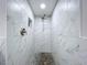 Walk-in shower featuring stone floors and tile walls with a shower niche at 10941 Hilltop Dr, New Port Richey, FL 34654