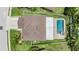 Aerial view of a home with an in-ground pool and fenced yard at 1104 Ketzal Dr, Trinity, FL 34655