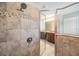 Tiled bathroom showcasing a shower stall with glass doors and an overhead showerhead at 1104 Ketzal Dr, Trinity, FL 34655