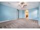 Spacious bedroom with light blue walls, carpet, and access to an ensuite bathroom at 1104 Ketzal Dr, Trinity, FL 34655