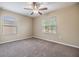 Bright bedroom with a ceiling fan and two windows, offering ample natural light at 1104 Ketzal Dr, Trinity, FL 34655