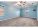 Bright bedroom with blue walls, carpet flooring, a ceiling fan and natural light at 1104 Ketzal Dr, Trinity, FL 34655