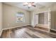 Bright bedroom with wood-look flooring, window, and an ensuite bathroom at 1104 Ketzal Dr, Trinity, FL 34655
