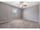 Neutral bedroom with a ceiling fan and a window, offering ample natural light at 1104 Ketzal Dr, Trinity, FL 34655