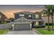 Charming two-story home featuring a well-manicured lawn and an attached two-car garage at 1104 Ketzal Dr, Trinity, FL 34655