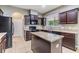 Kitchen features granite countertops, dark wood cabinets, stainless steel appliances and an island at 1104 Ketzal Dr, Trinity, FL 34655