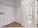 Bright laundry room with tile floors, wire shelving and a door to the exterior at 1104 Ketzal Dr, Trinity, FL 34655