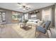 Inviting living room offers lots of natural light and neutral finishes, leading out to the screened in patio at 1104 Ketzal Dr, Trinity, FL 34655