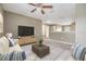 Inviting living room with stylish furniture, a ceiling fan, and a view of the hallway at 1104 Ketzal Dr, Trinity, FL 34655