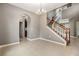 Bright living room features tile floors, neutral paint, staircase and arched doorways leading to the kitchen at 1104 Ketzal Dr, Trinity, FL 34655
