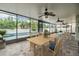 Enclosed patio area features a paver floor, ceiling fans, and views of the backyard pool and landscaping at 1104 Ketzal Dr, Trinity, FL 34655