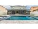 Backyard in-ground pool and screened-in patio at 1104 Ketzal Dr, Trinity, FL 34655