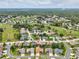 Aerial view of a residential neighborhood featuring well-maintained homes and tree-lined streets at 11144 Brambleleaf Way, Hudson, FL 34667