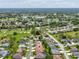 Aerial view of a residential community surrounded by golf courses and lush greenery at 11144 Brambleleaf Way, Hudson, FL 34667
