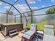 Relaxing backyard with a hot tub, lounge chairs, and a covered patio at 11144 Brambleleaf Way, Hudson, FL 34667