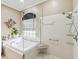 Bright bathroom featuring a luxurious soaking tub and a glass-enclosed shower at 11144 Brambleleaf Way, Hudson, FL 34667