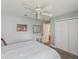 Bright bedroom featuring a ceiling fan and a closet with white doors at 11144 Brambleleaf Way, Hudson, FL 34667
