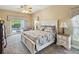 Bright bedroom features a sliding glass door leading to the pool area, providing a tranquil retreat at 11144 Brambleleaf Way, Hudson, FL 34667