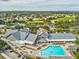 Expansive clubhouse featuring a swimming pool, golf course, tennis courts, and well-manicured lawns at 11144 Brambleleaf Way, Hudson, FL 34667