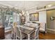 Elegant dining room with a large window, chandelier lighting, and stylish decor and furniture at 11144 Brambleleaf Way, Hudson, FL 34667