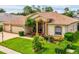 A lovely single-story home showcasing a well-kept lawn, mature trees, and an inviting front entrance at 11144 Brambleleaf Way, Hudson, FL 34667