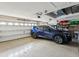 Spacious garage featuring epoxy flooring, storage shelves and blue SUV at 11144 Brambleleaf Way, Hudson, FL 34667
