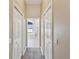 Hallway view of bathroom featuring white doors and neutral carpeting at 11144 Brambleleaf Way, Hudson, FL 34667