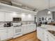 Contemporary kitchen with white cabinets, stainless steel appliances, marble backsplash, and granite countertops at 11144 Brambleleaf Way, Hudson, FL 34667