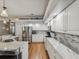 Bright kitchen features white cabinets, stainless appliances, and sleek marble countertops, creating a modern space at 11144 Brambleleaf Way, Hudson, FL 34667