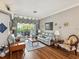 Bright and stylish living room with hardwood floors, comfortable seating, and access to the outdoor patio at 11144 Brambleleaf Way, Hudson, FL 34667