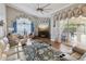 Bright living room with vaulted ceiling, comfortable seating, and a view to a pool at 11144 Brambleleaf Way, Hudson, FL 34667
