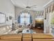 Spacious living room with hardwood floors, large windows, and cozy fireplace offers ample natural light at 11144 Brambleleaf Way, Hudson, FL 34667