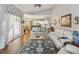 Spacious living room with access to the kitchen, dining area, and views of a sunroom at 11144 Brambleleaf Way, Hudson, FL 34667