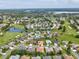 Beautiful community aerial view near a golf course, water feature, and other well-maintained homes at 11144 Brambleleaf Way, Hudson, FL 34667