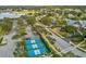 Community pickleball courts with blue surfaces, nestled among trees and a paved road at 11144 Brambleleaf Way, Hudson, FL 34667