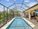 A refreshing screened-in pool, perfect for relaxation and entertainment, adjacent to an outdoor seating area at 11144 Brambleleaf Way, Hudson, FL 34667