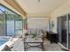 Inviting covered patio lounge area with comfortable seating, decor, and views of the screened-in pool area for relaxing at 11144 Brambleleaf Way, Hudson, FL 34667
