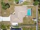 Aerial view showcases a backyard with a screened-in pool and white fencing surrounding the property at 11280 Sedgefield Ave, Spring Hill, FL 34608