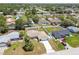 Lovely aerial view of a quaint home featuring a long driveway, a fenced backyard, and mature trees at 11280 Sedgefield Ave, Spring Hill, FL 34608