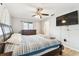 Bedroom with a ceiling fan, wood-look flooring, and a large bed at 11280 Sedgefield Ave, Spring Hill, FL 34608