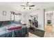 Bedroom with wood-look flooring, ceiling fan, and exercise equipment at 11280 Sedgefield Ave, Spring Hill, FL 34608