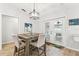 Bright dining area with modern wood table, comfortable chairs, and sliding glass doors at 11280 Sedgefield Ave, Spring Hill, FL 34608