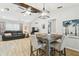 Dining room with wooden table, view of open living room, and modern ceiling fan at 11280 Sedgefield Ave, Spring Hill, FL 34608