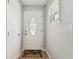 Clean entryway with white door, neutral walls, wood-look floors, and a decorative window at 11280 Sedgefield Ave, Spring Hill, FL 34608
